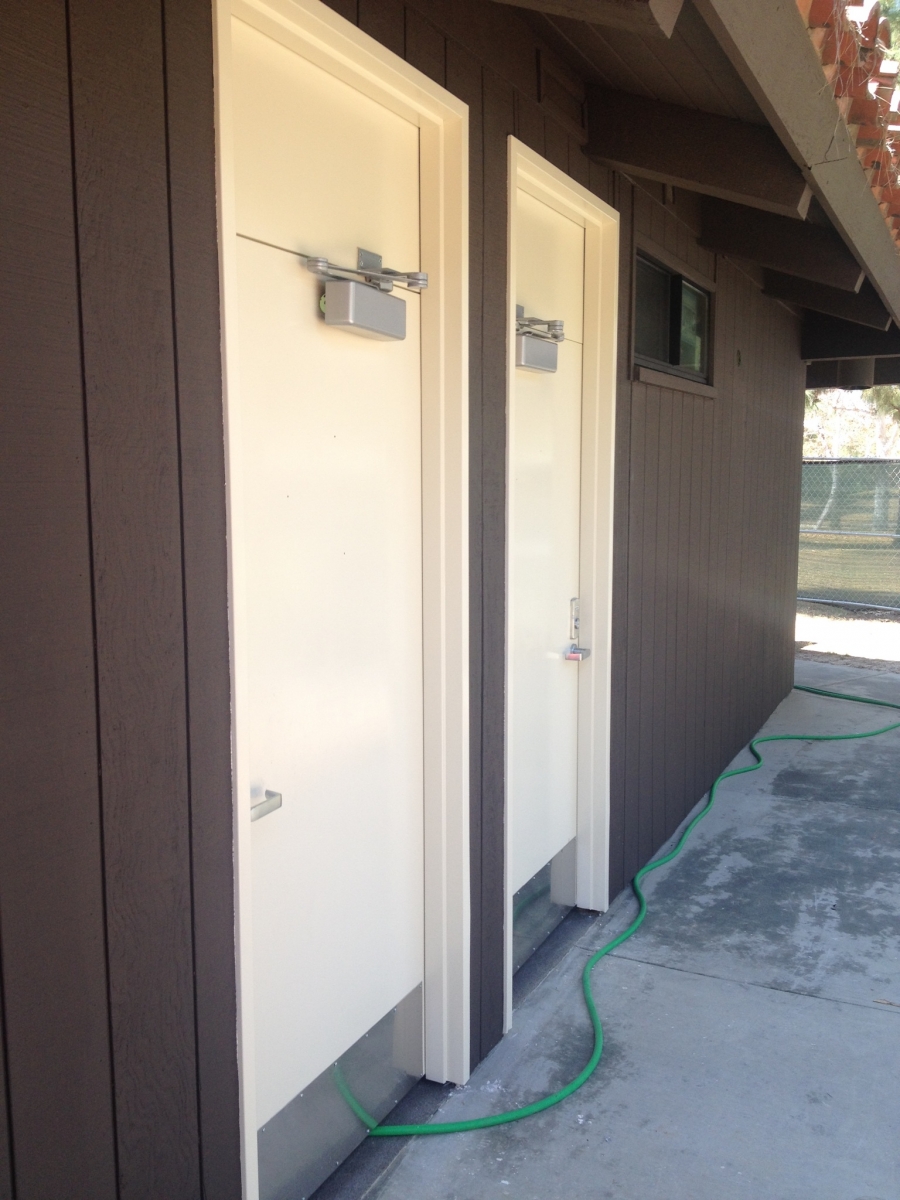 Exterior renovation of a public restroom building, new doors and siding